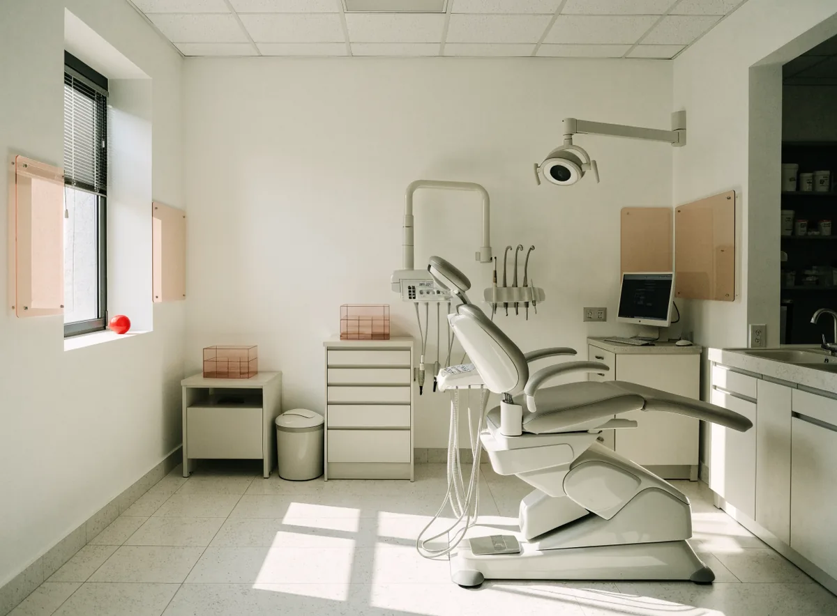 Dental chair beside a sunlit window (illustrative)