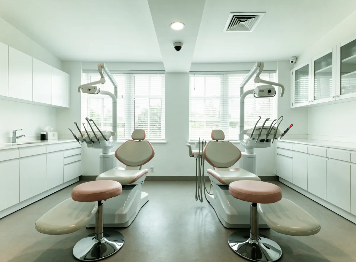 Dental treatment chairs in a bright open clinic (illustrative)