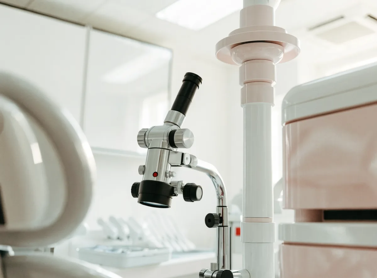 Dental operating microscope in a treatment room (illustrative)